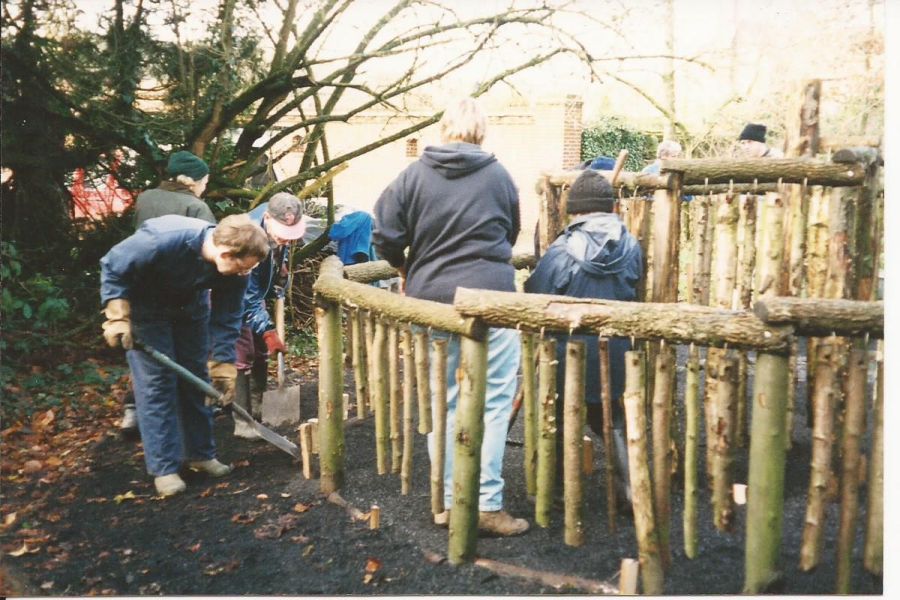 Special needs group building fence structure at Bore Place